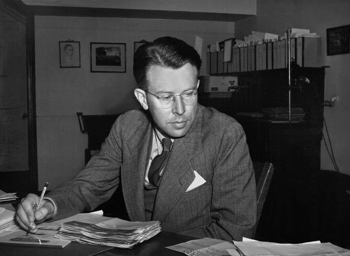 Ernest Orlando Lawrence sitting at a desk with pencil in hand, reference best picture given to Walke.